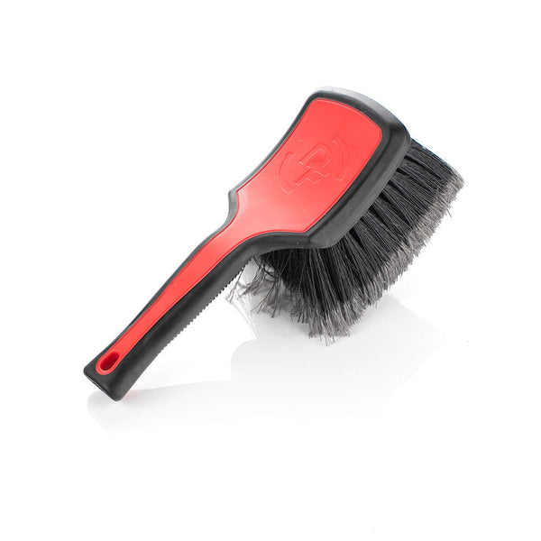 A red Detail Factory Wheel Face brush on a white background.