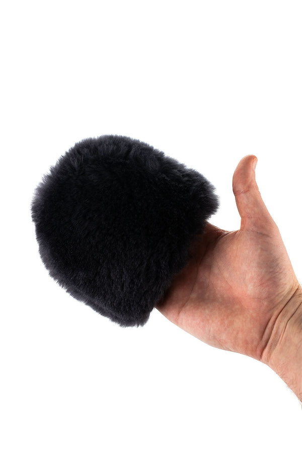 A person holding the Ultra Wheel Mitt in front of a white background.